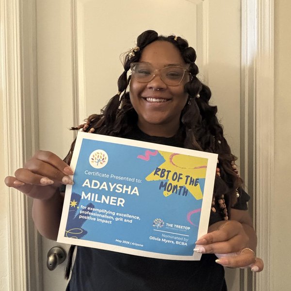 Adaysha Milner holding her BT of the Month certificate