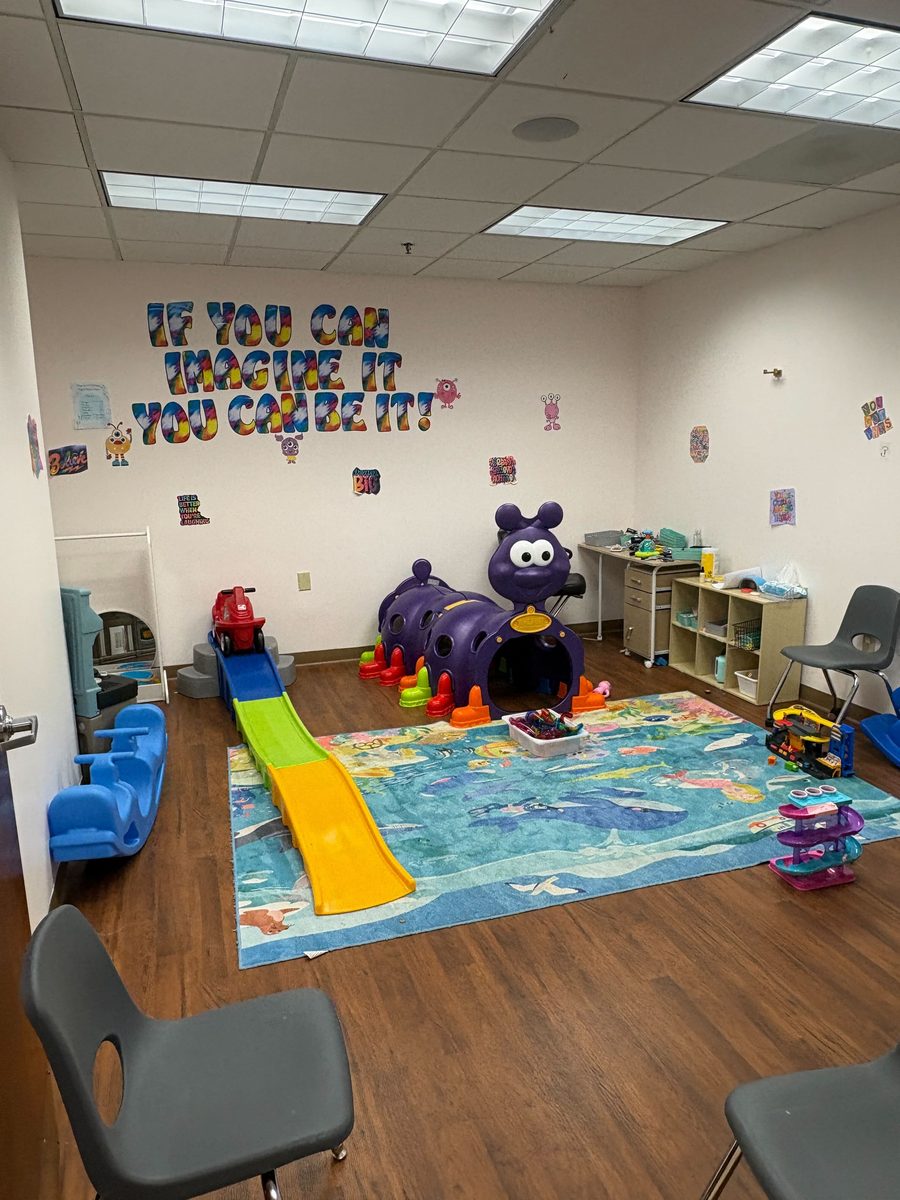 Play room with caterpillar tunnel and If you can imagine it wall
