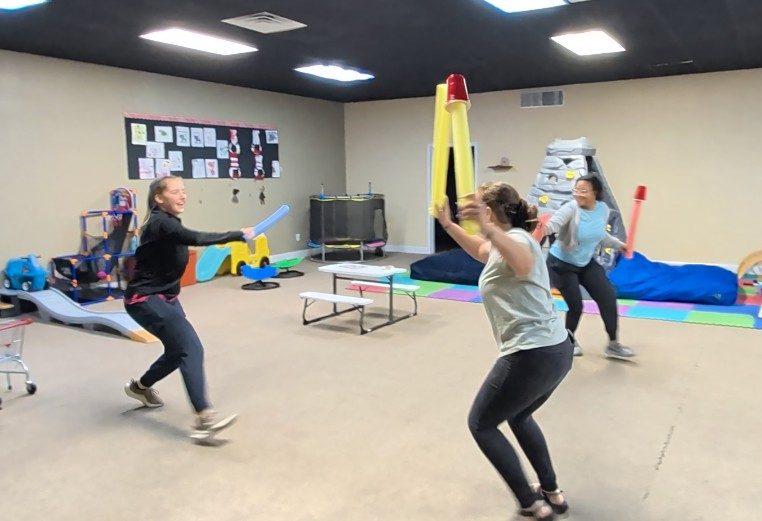 Killeen staff team-building with pool noodles