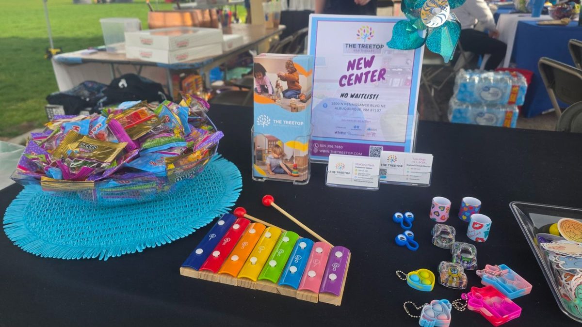 Treetop booth table with xylophone, candies and New Center flyer