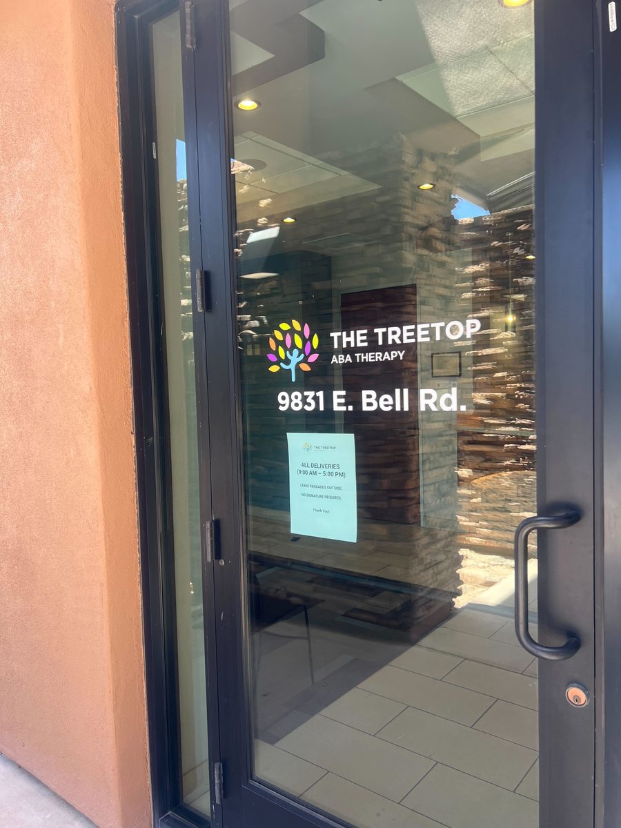 Treetop Scottsdale clinic glass door with 9831 E. Bell Rd address
