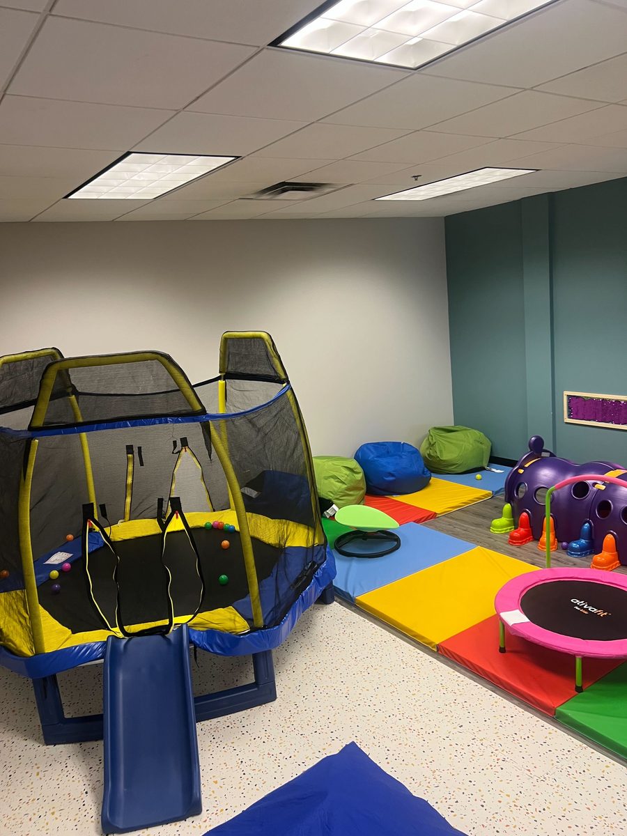 Sensory play room with trampoline, mats and toys