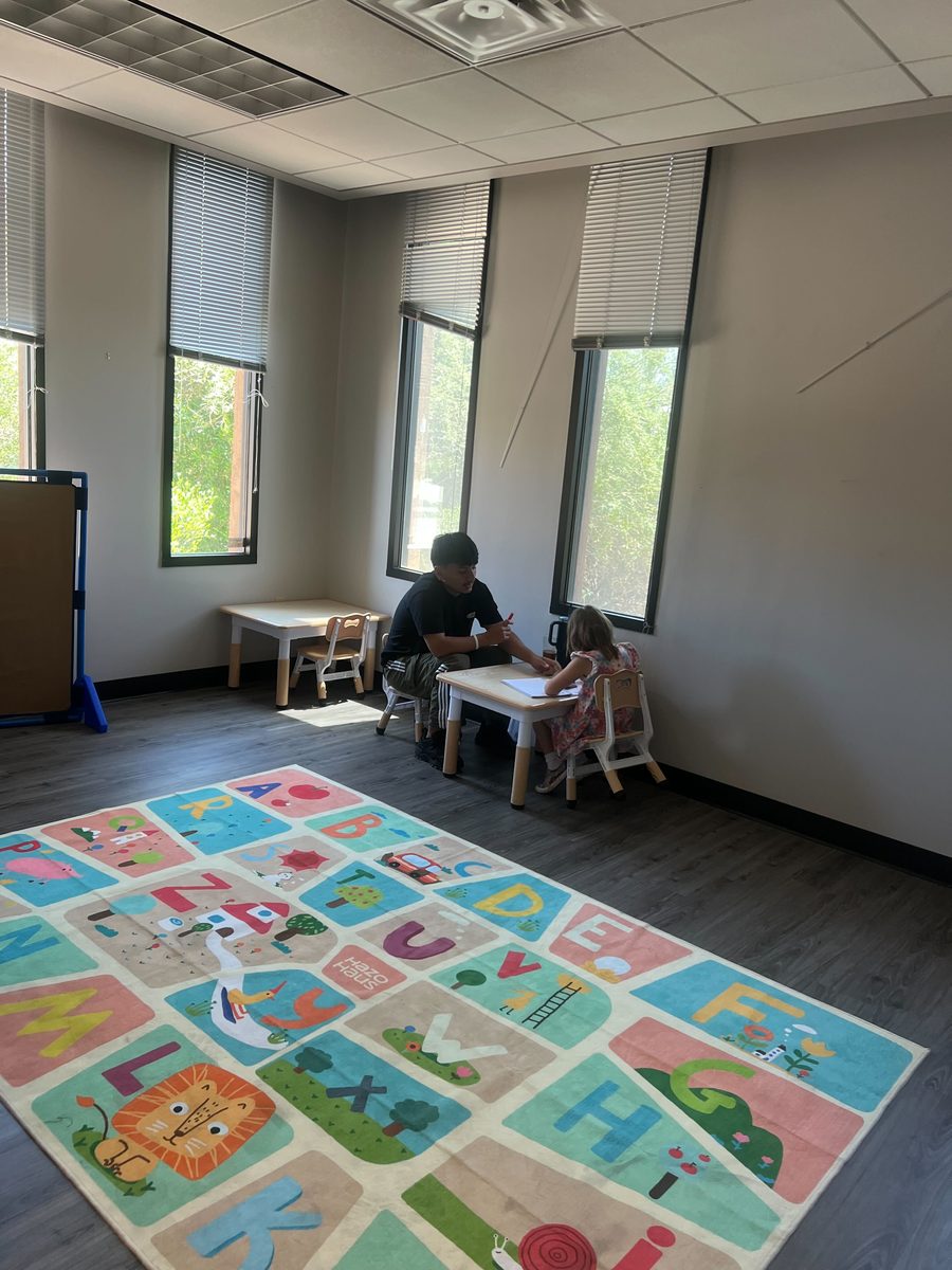 Therapist working with a client at a small table